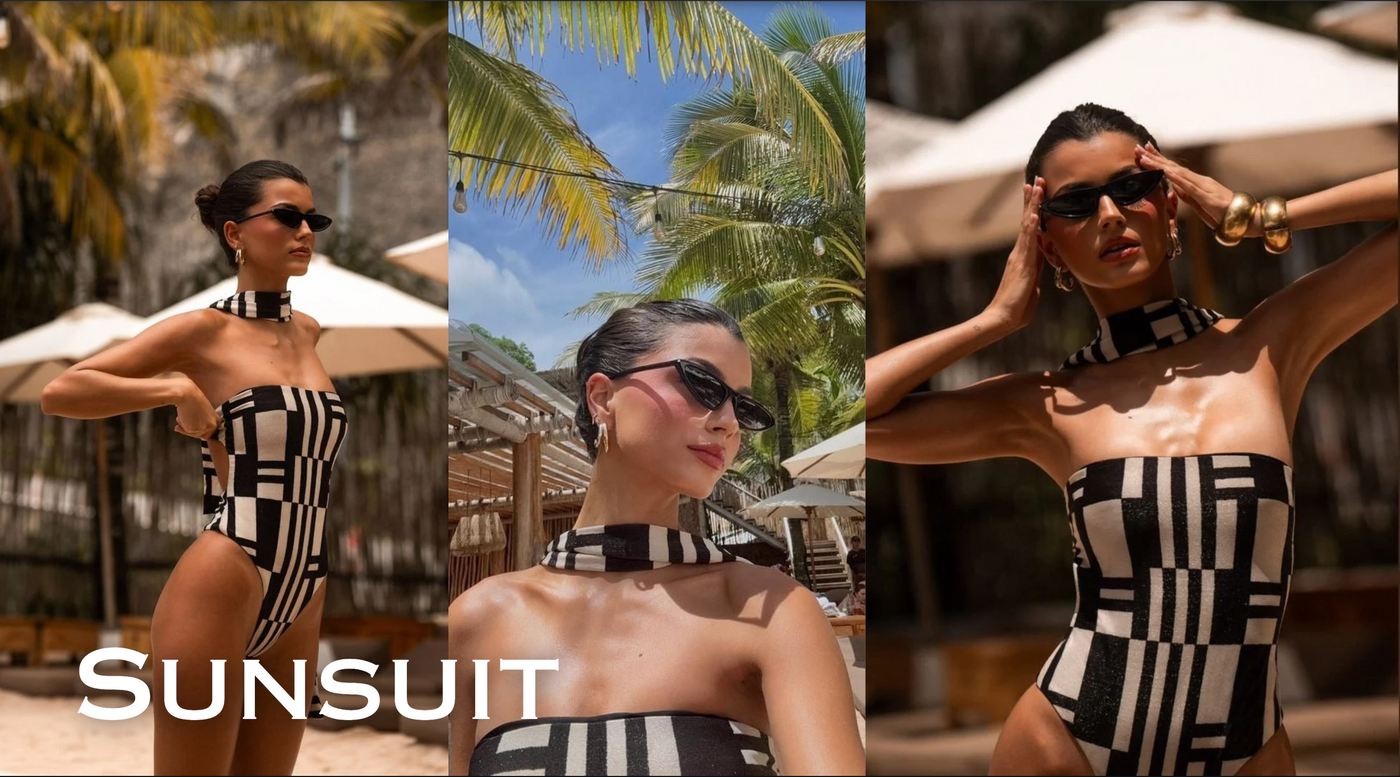 Woman in a black and white checkered swimsuit with palm trees and beach umbrellas in the background.