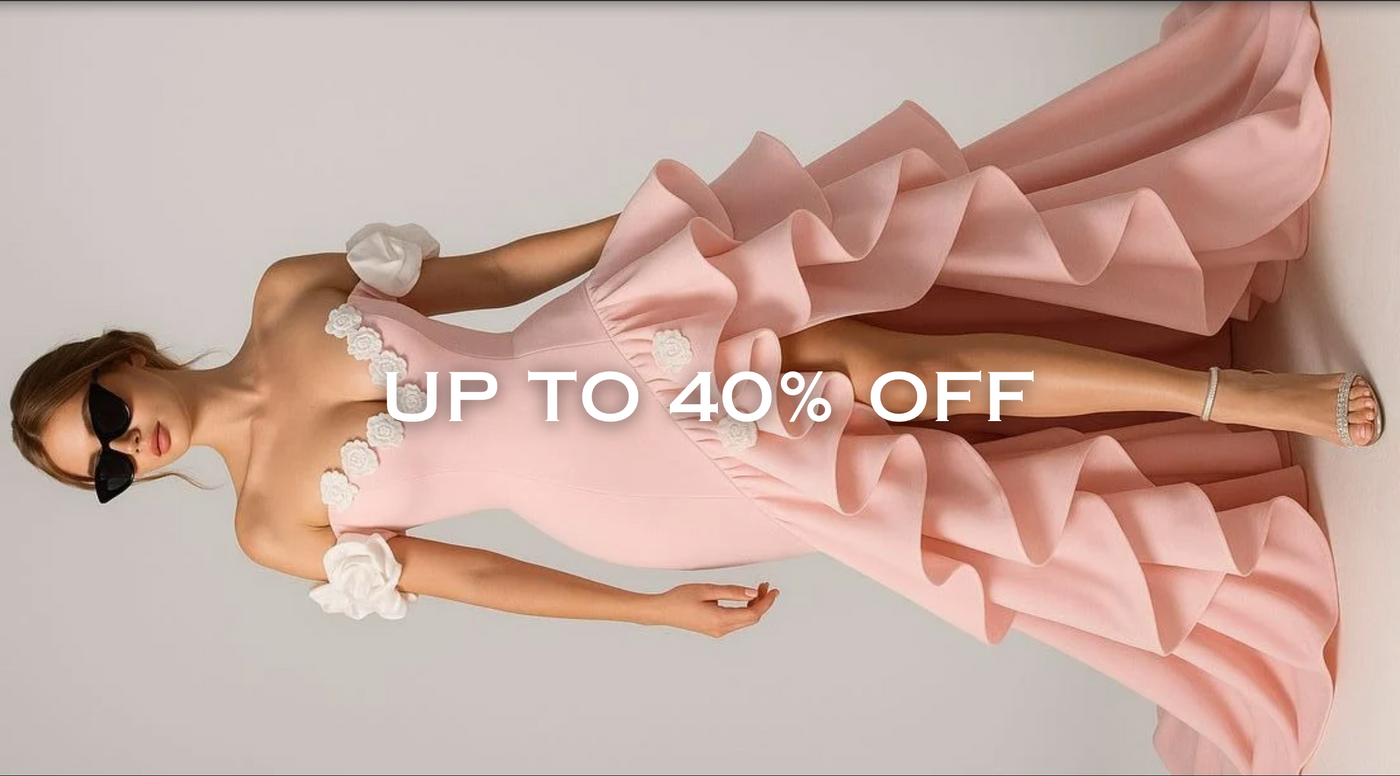 Woman in a pink gown with ruffles on a gray background, featuring a discount text overlay.